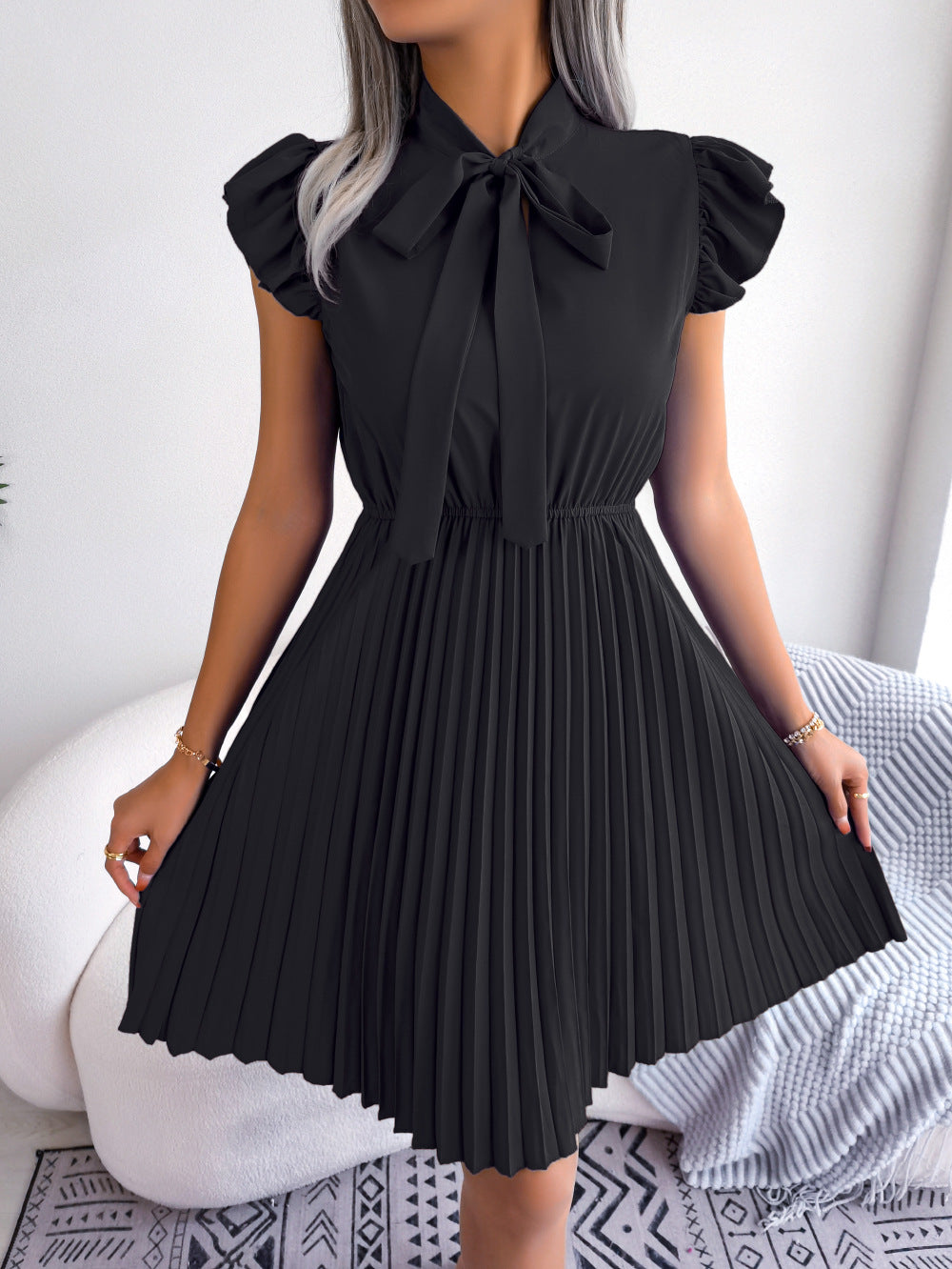 Realistic photo of 2025 European and American spring and summer temperament, tie up waist, big hem pleated skirt